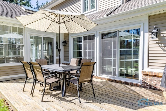wooden terrace with outdoor dining space