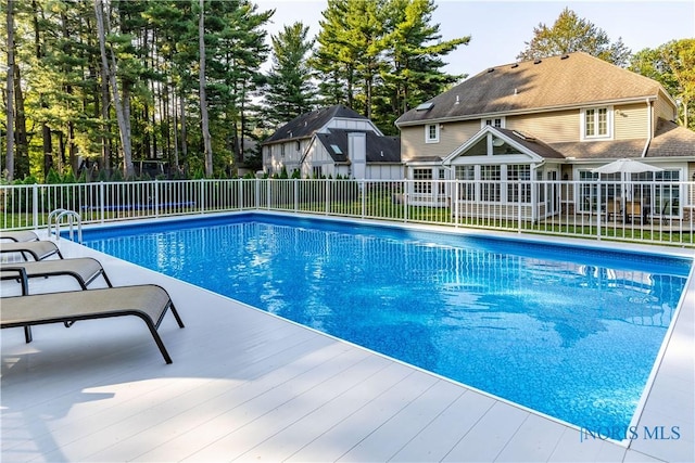 view of swimming pool with fence, a fenced in pool, and a deck