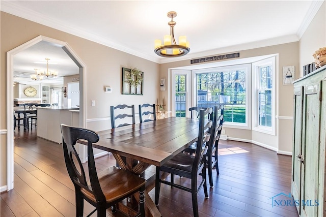 dining area with baseboards, a notable chandelier, dark wood-style floors, and ornamental molding