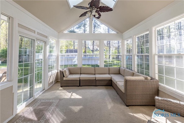 sunroom with a ceiling fan, a wealth of natural light, and vaulted ceiling
