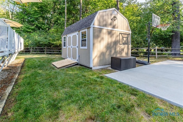 view of shed with central air condition unit and a fenced backyard