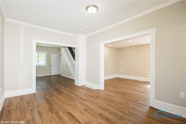 303 Short St, Napoleon, OH 43545 - unfurnished room with stairs, baseboards, ornamental molding, and wood finished floors