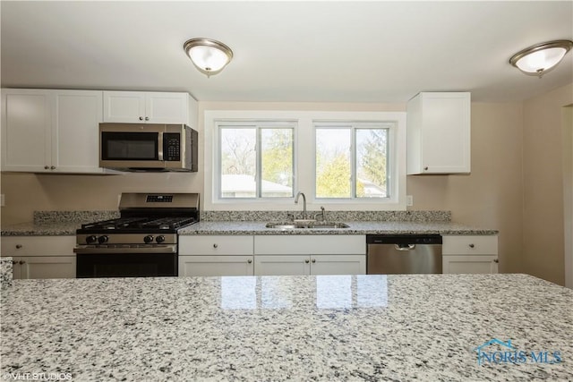 303 Short St, Napoleon, OH 43545 - kitchen with stainless steel appliances, light stone countertops, and a sink