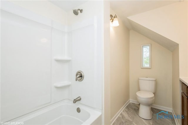 bathroom with vanity, marble finish floor, toilet, baseboards, and shower / bath combination