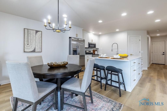 26328 Stillwater Dr, Perrysburg, OH 43551 - dining area with light wood-type flooring, a chandelier, recessed lighting, and baseboards