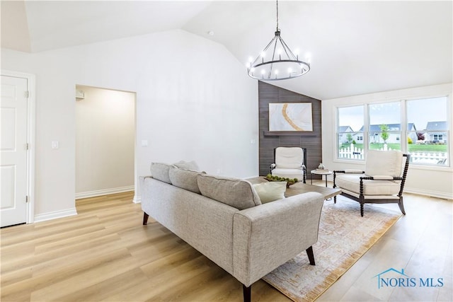 26328 Stillwater Dr, Perrysburg, OH 43551 - living area featuring a chandelier, light wood-style flooring, high vaulted ceiling, and baseboards