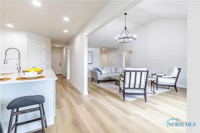 26328 Stillwater Dr, Perrysburg, OH 43551 - dining space featuring light wood-style flooring, a chandelier, baseboards, recessed lighting, and vaulted ceiling