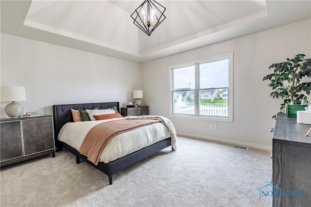 26328 Stillwater Dr, Perrysburg, OH 43551 - bedroom with a tray ceiling, light carpet, a chandelier, and baseboards