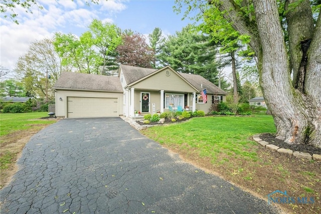 single story home with a porch, a garage, a front lawn, and driveway