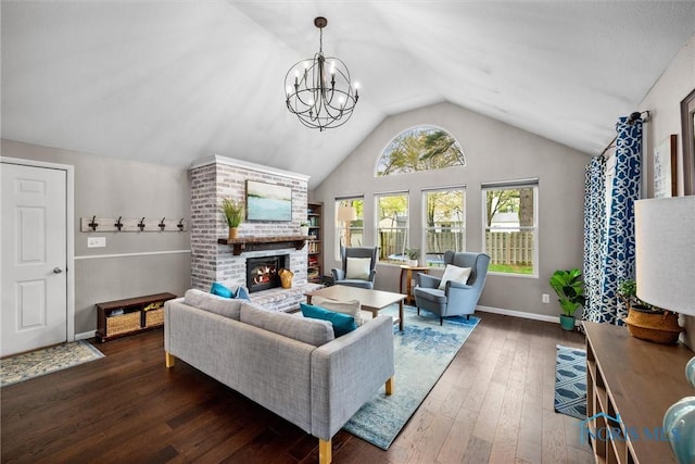 living area with a brick fireplace, baseboards, a notable chandelier, lofted ceiling, and hardwood / wood-style floors