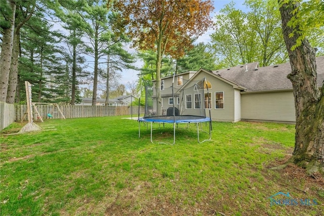 view of yard featuring a fenced backyard and a trampoline