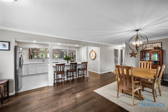dining area featuring an inviting chandelier, recessed lighting, dark wood-style flooring, and crown molding
