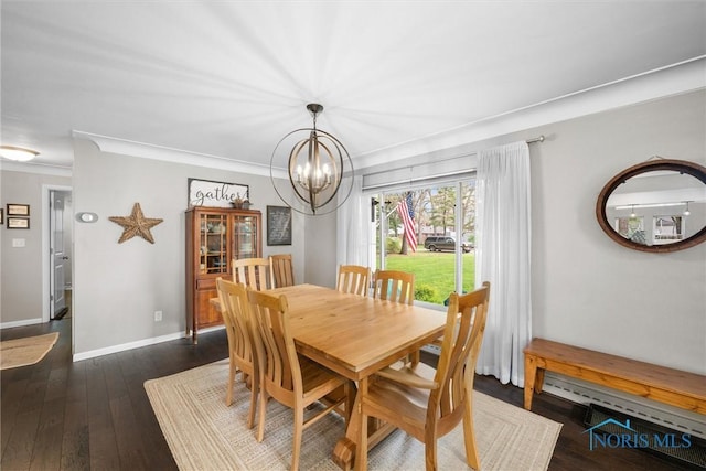 dining room featuring an inviting chandelier, baseboards, crown molding, and dark wood finished floors