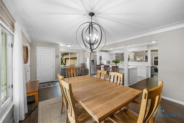 dining area with baseboards, a chandelier, and a healthy amount of sunlight