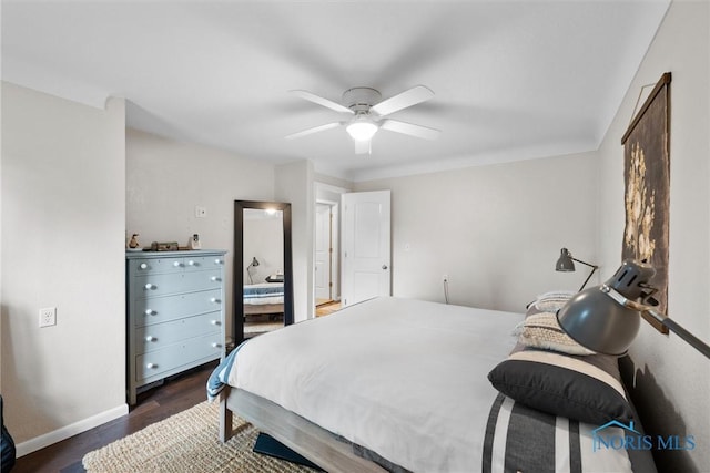 bedroom featuring baseboards, ceiling fan, and dark wood-style floors
