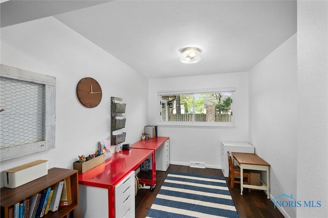 office space featuring visible vents, baseboards, and wood finished floors