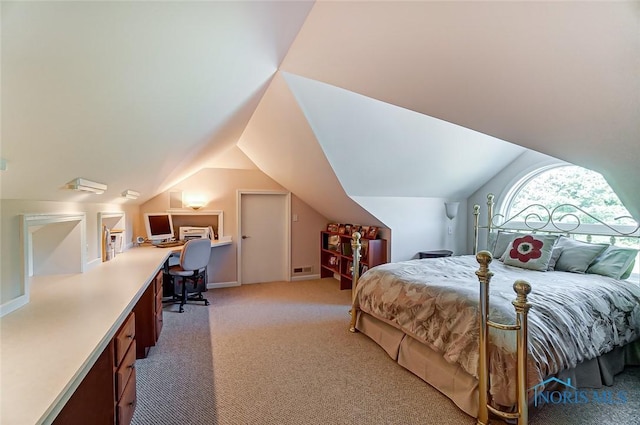 bedroom with light colored carpet and lofted ceiling