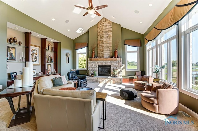 carpeted living area with a ceiling fan, a stone fireplace, visible vents, high vaulted ceiling, and recessed lighting