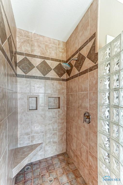 bathroom with a tile shower