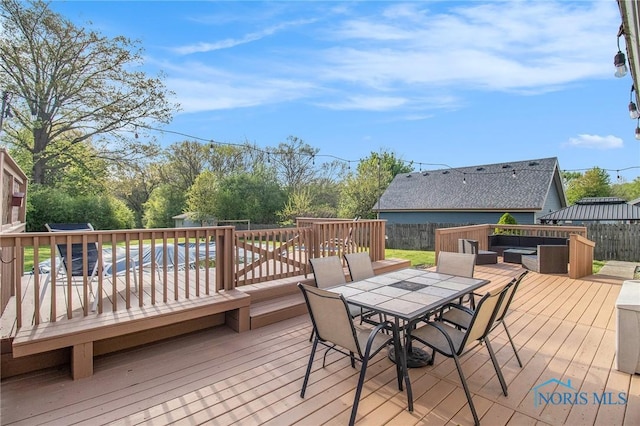 29058 White Rd, Perrysburg, OH 43551 - wooden deck featuring an outdoor living space, outdoor dining area, and a fenced backyard
