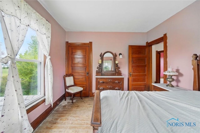 13707 Brint Rd, Berkey, OH 43504 - bedroom featuring light wood-style flooring and baseboards