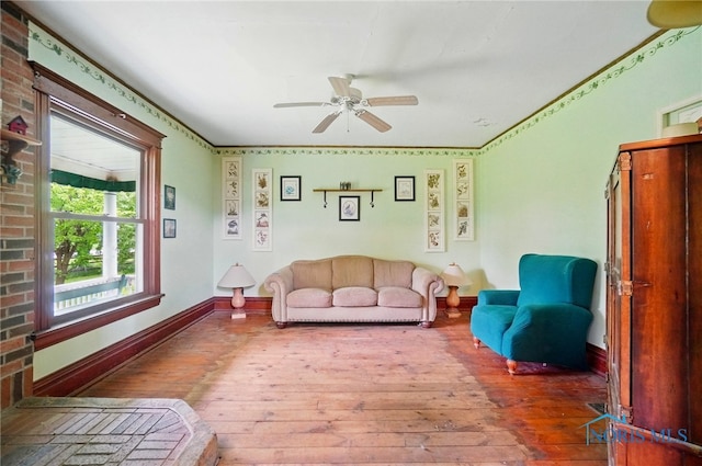13707 Brint Rd, Berkey, OH 43504 - living area featuring wood-type flooring, ceiling fan, and baseboards