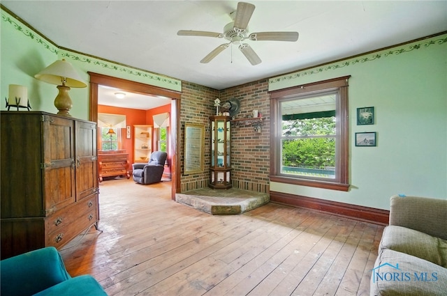 13707 Brint Rd, Berkey, OH 43504 - living area featuring hardwood / wood-style floors, baseboards, and ceiling fan