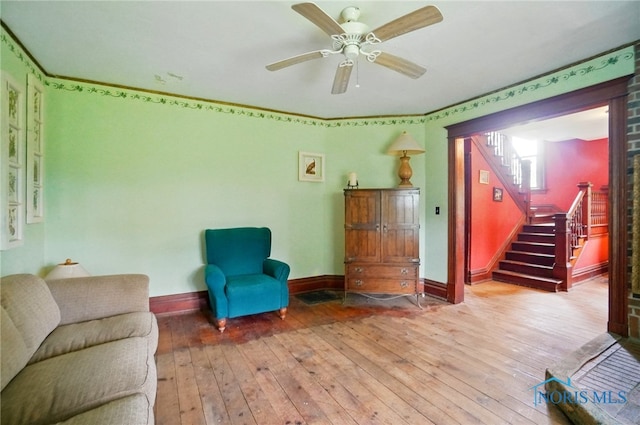 13707 Brint Rd, Berkey, OH 43504 - living area with hardwood / wood-style flooring, stairway, baseboards, and ceiling fan