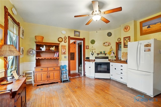 13707 Brint Rd, Berkey, OH 43504 - kitchen with freestanding refrigerator, electric stove, light wood-type flooring, a ceiling fan, and a wainscoted wall