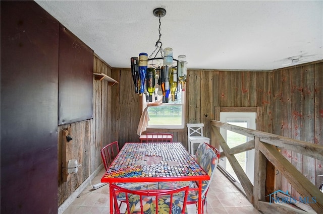 13707 Brint Rd, Berkey, OH 43504 - dining space featuring wooden walls and a chandelier