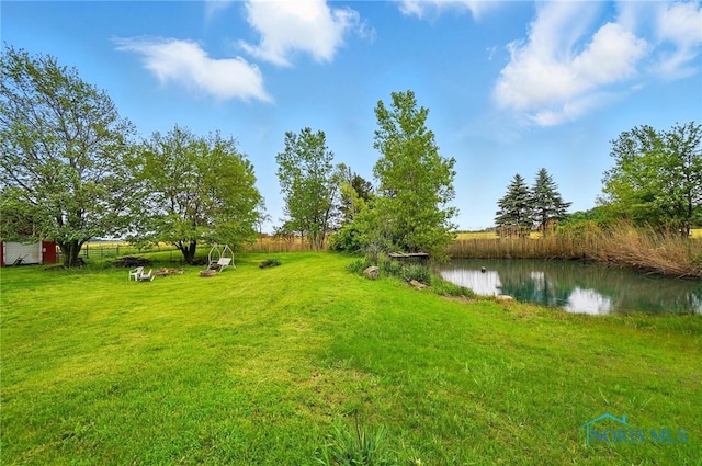 13707 Brint Rd, Berkey, OH 43504 - view of green lawn featuring a water view
