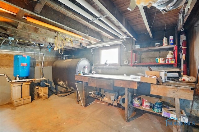 13707 Brint Rd, Berkey, OH 43504 - basement with heating fuel, a workshop area, and a water pressure tank