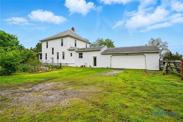 13707 Brint Rd, Berkey, OH 43504 - rear view of property with a chimney and an attached garage