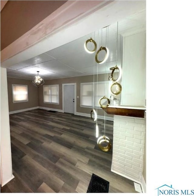 interior space with visible vents, dark wood finished floors, and baseboards