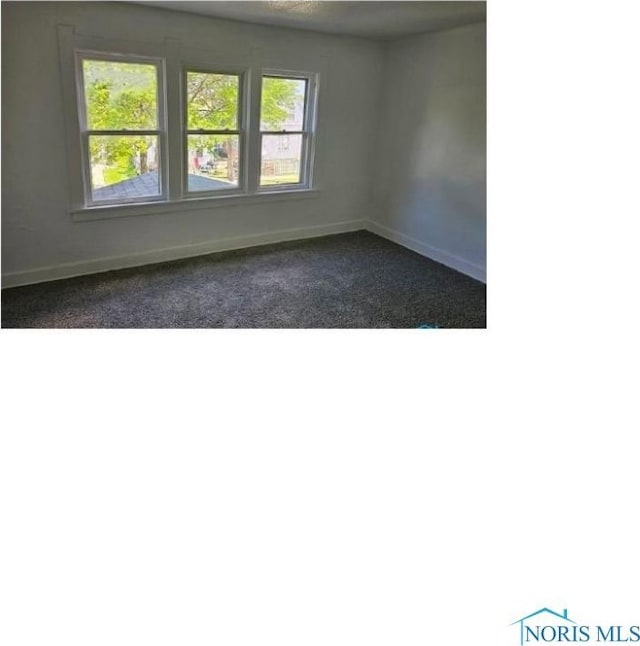 spare room featuring baseboards
