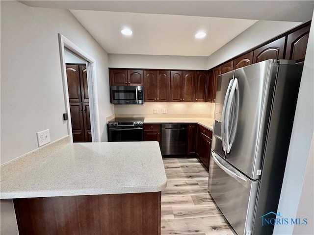 kitchen featuring light wood-type flooring, dark brown cabinets, light countertops, stainless steel appliances, and recessed lighting