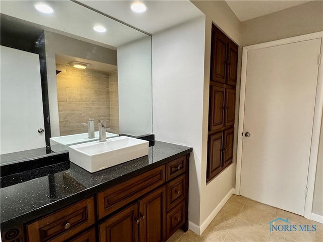 bathroom with recessed lighting, baseboards, tile patterned floors, and vanity