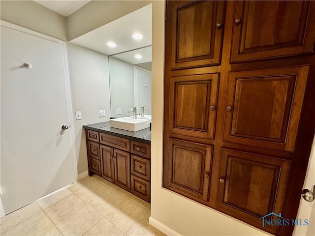 bathroom with recessed lighting, baseboards, tile patterned flooring, and vanity