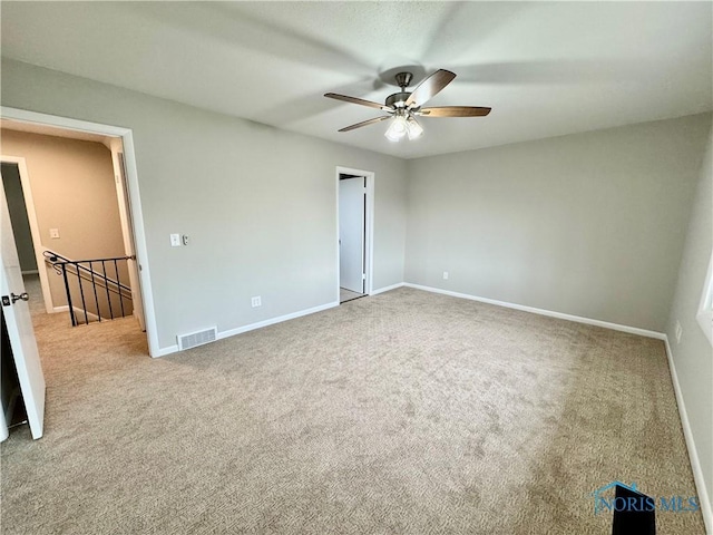 unfurnished bedroom featuring visible vents, carpet flooring, baseboards, and a ceiling fan
