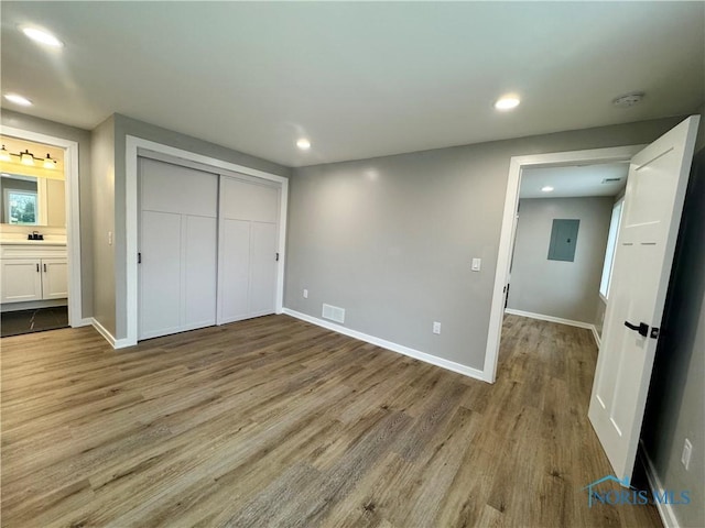 unfurnished bedroom with baseboards, recessed lighting, and wood finished floors
