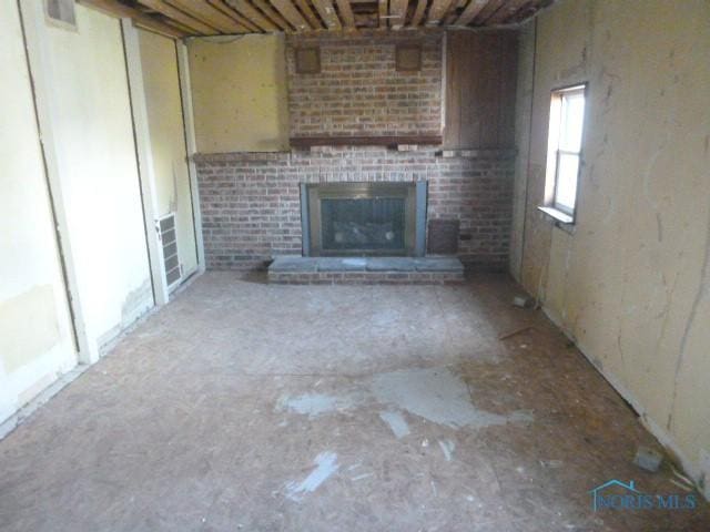 unfurnished living room featuring visible vents and a fireplace