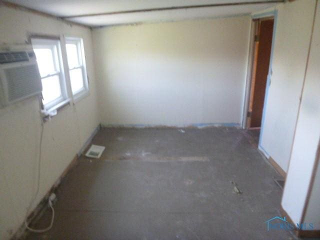 unfurnished room featuring visible vents