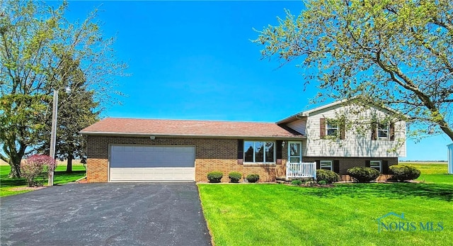 24046 Defiance Pike, Custar, OH 43511 - tri-level home featuring an attached garage, brick siding, driveway, and a front yard