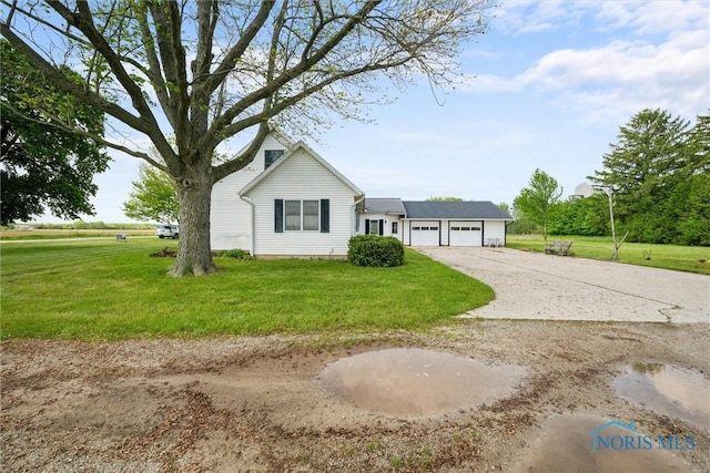 5788 Emerson Rd, Bloomdale, OH 44817 - view of front of property with a garage, driveway, and a front yard