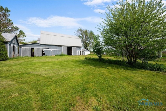 5788 Emerson Rd, Bloomdale, OH 44817 - view of grassy yard with an outdoor structure and a barn
