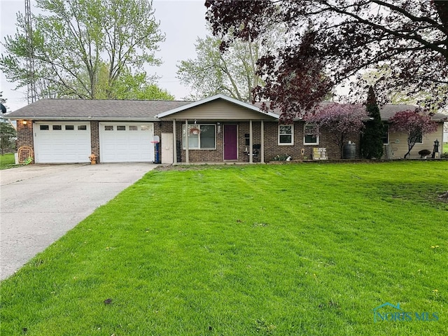 ranch-style home with an attached garage, brick siding, driveway, and a front yard