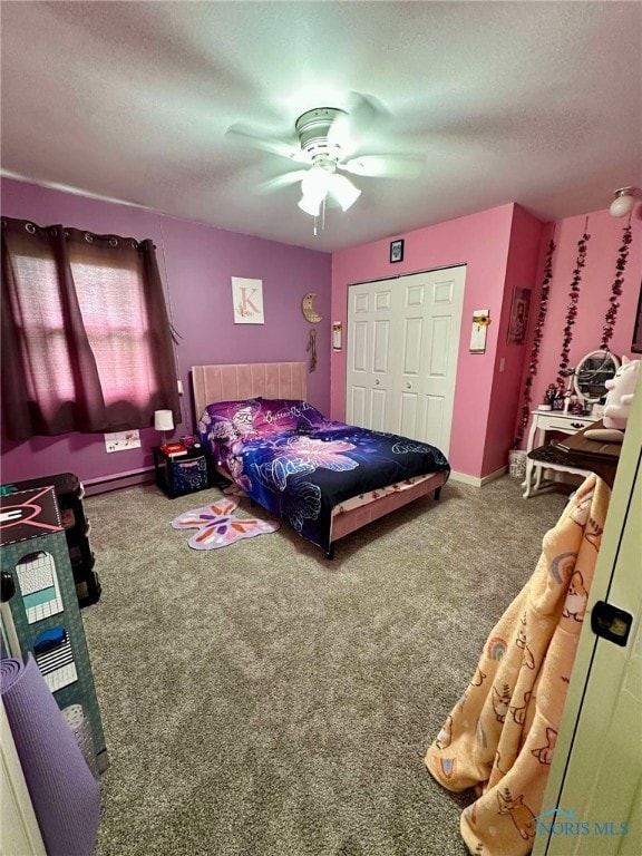 bedroom featuring a closet, ceiling fan, a textured ceiling, a baseboard radiator, and carpet
