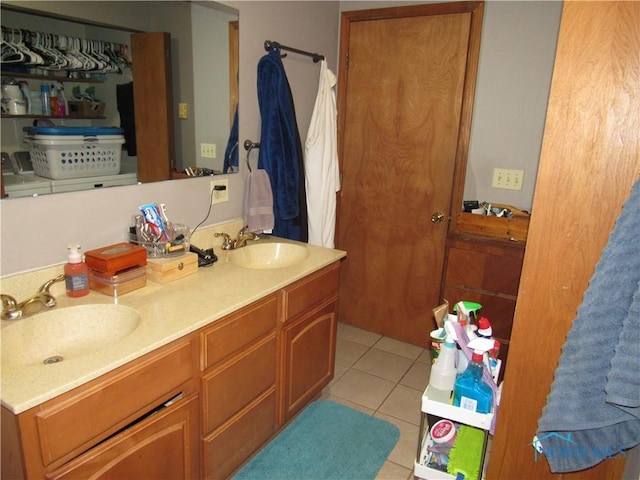full bathroom featuring double vanity, tile patterned floors, and a sink