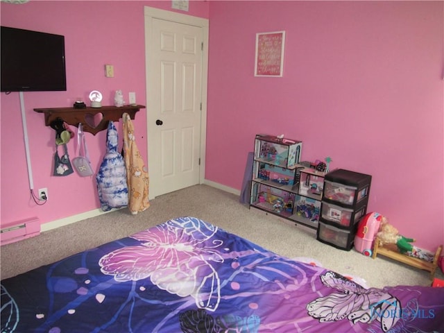 carpeted bedroom featuring baseboard heating