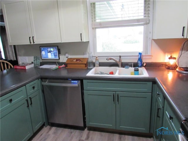kitchen with dishwasher, green cabinets, light wood finished floors, a sink, and white cabinetry